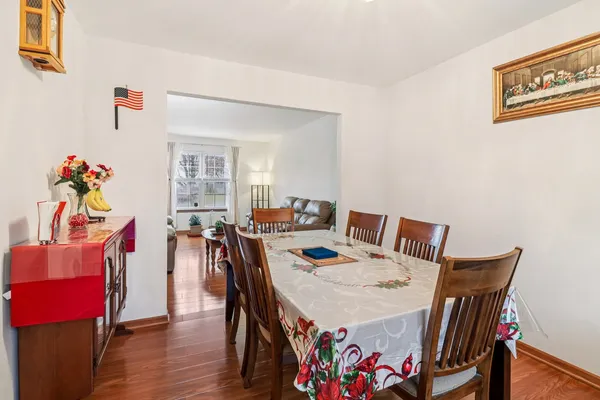 a view of a dining room with furniture and wooden floor