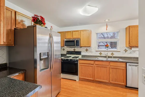 a kitchen with a sink stove and refrigerator