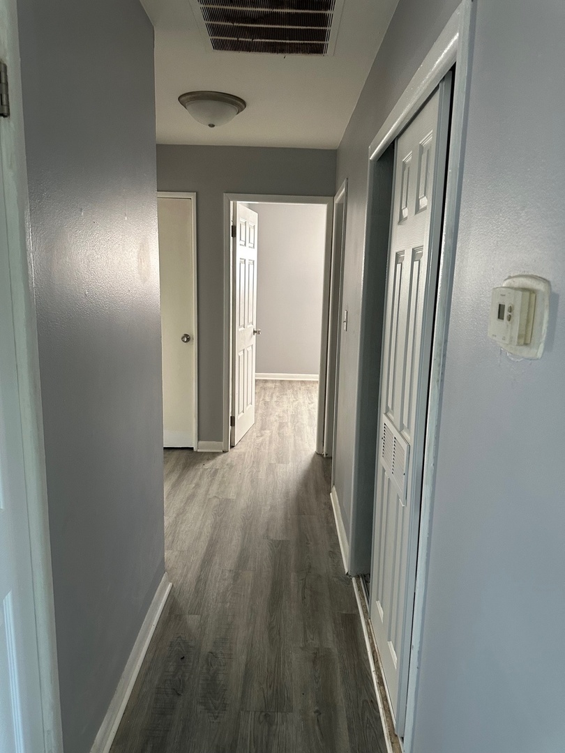 2956 Sherwood Avenue Markham, IL 60428 - Photo 4 of 13 a view of a hallway with wooden floor