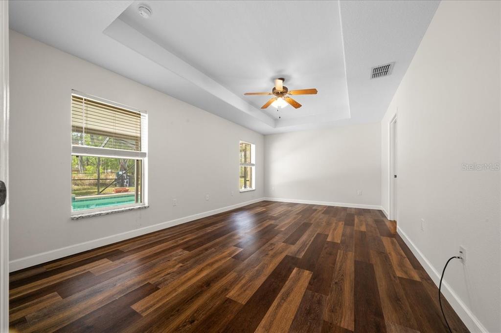 234 Locust Lane Ocala, FL 34472 - Photo 52 of 71 a view of empty room with wooden floor and window
