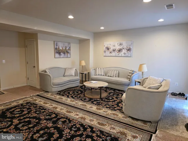 a living room with furniture and a rug
