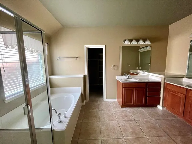 a bathroom with a tub and shower