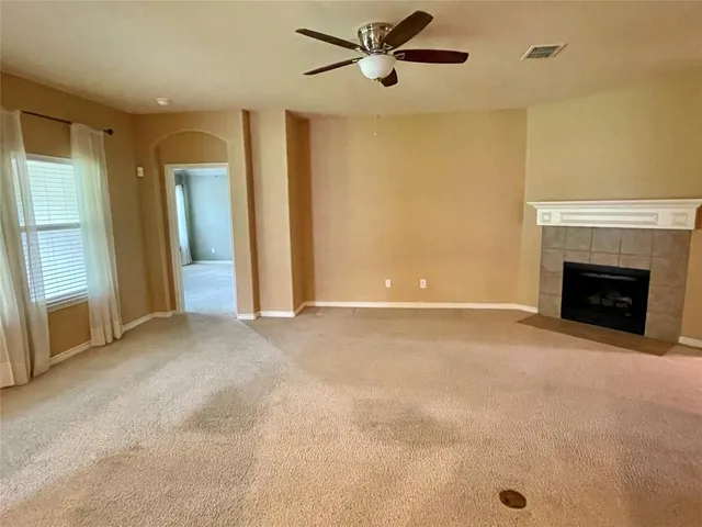 a view of an empty room with a fireplace