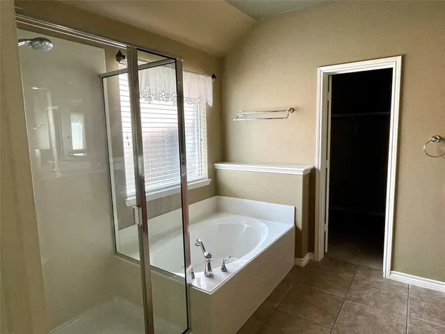 a bathroom with a tub and shower