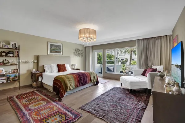 a spacious bedroom with a bed a couch and a window