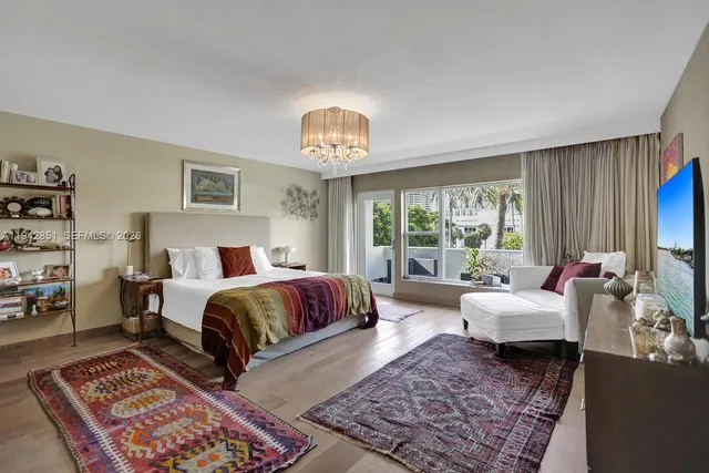 a spacious bedroom with a bed a couch and a window