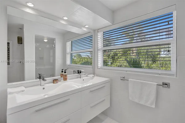 a bathroom with a sink and a large mirror