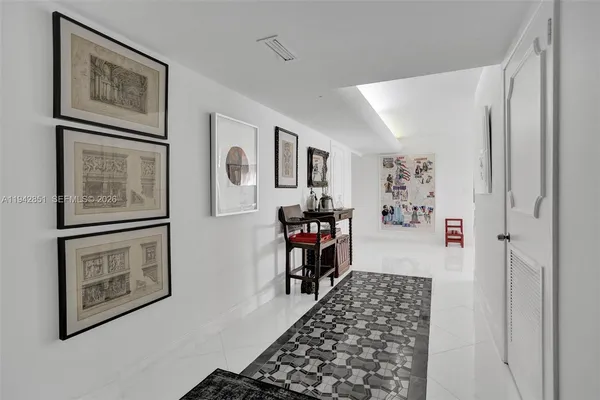a hallway with two painting on the wall and paintings on the wall
