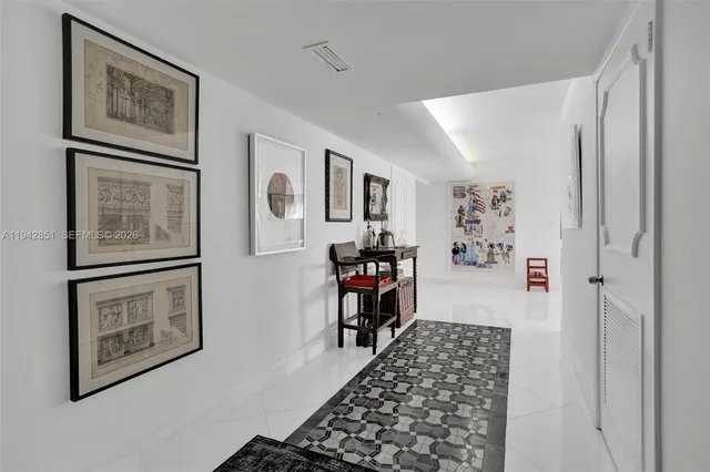 a hallway with two painting on the wall and paintings on the wall