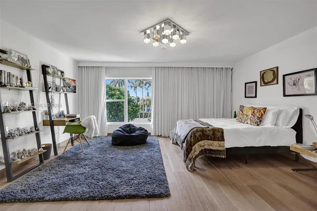 a bedroom with a bed a couch and a window