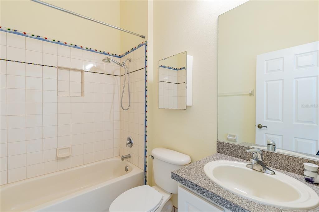 2718 Knightsbridge Road Clermont, FL 34711 - Photo 16 of 72 a bathroom with a granite countertop sink toilet and shower