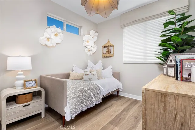a bedroom with bed and a chandelier