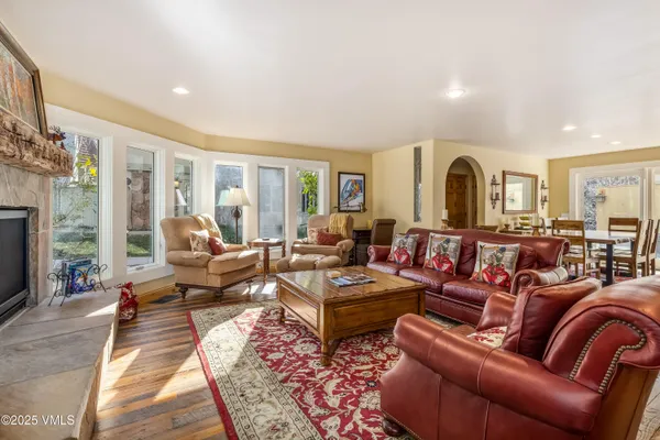 a living room with furniture fireplace and a window