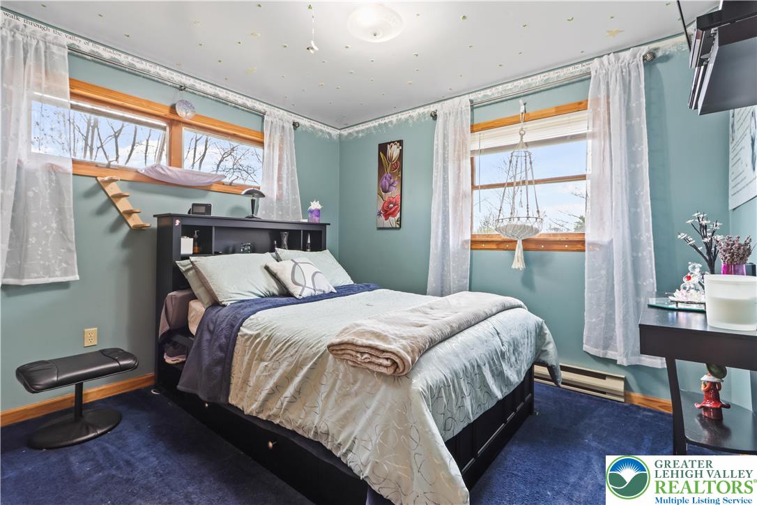 3134 Ross Road Saylorsburg, PA 18353 - Photo 14 of 47 a bedroom with a bed a dresser and a window