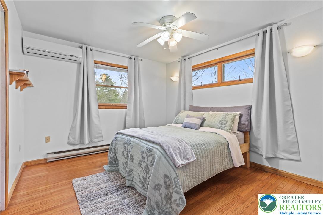 3134 Ross Road Saylorsburg, PA 18353 - Photo 19 of 47 a bedroom with a bed and a chandelier