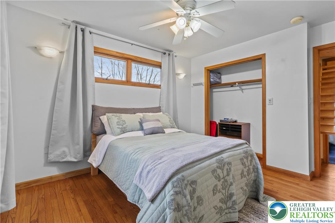 3134 Ross Road Saylorsburg, PA 18353 - Photo 21 of 47 a bedroom with a bed and a chandelier