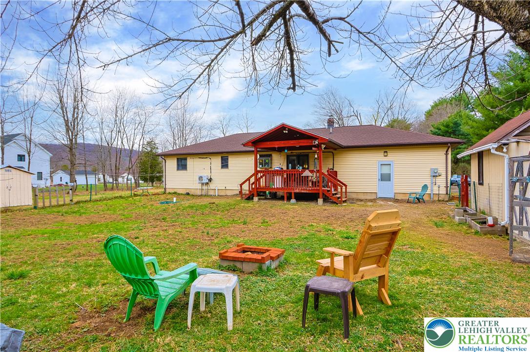 3134 Ross Road Saylorsburg, PA 18353 - Photo 31 of 47 a view of a swimming pool with a table and chairs under an umbrella