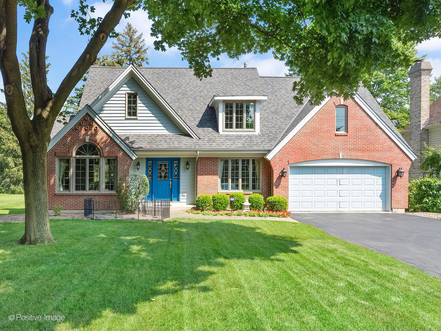 a front view of a house with a yard and porch