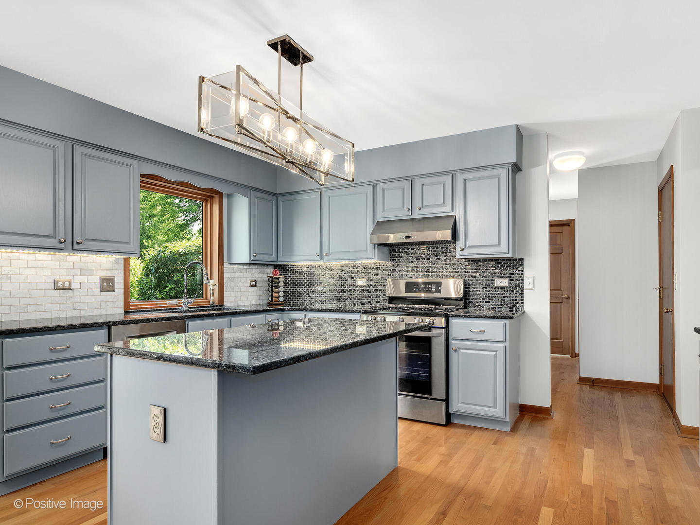 27W220 Jewell Road Winfield, IL 60190 - Photo 12 of 29 a kitchen with stainless steel appliances granite countertop a stove a sink dishwasher a refrigerator and white cabinets with wooden floor