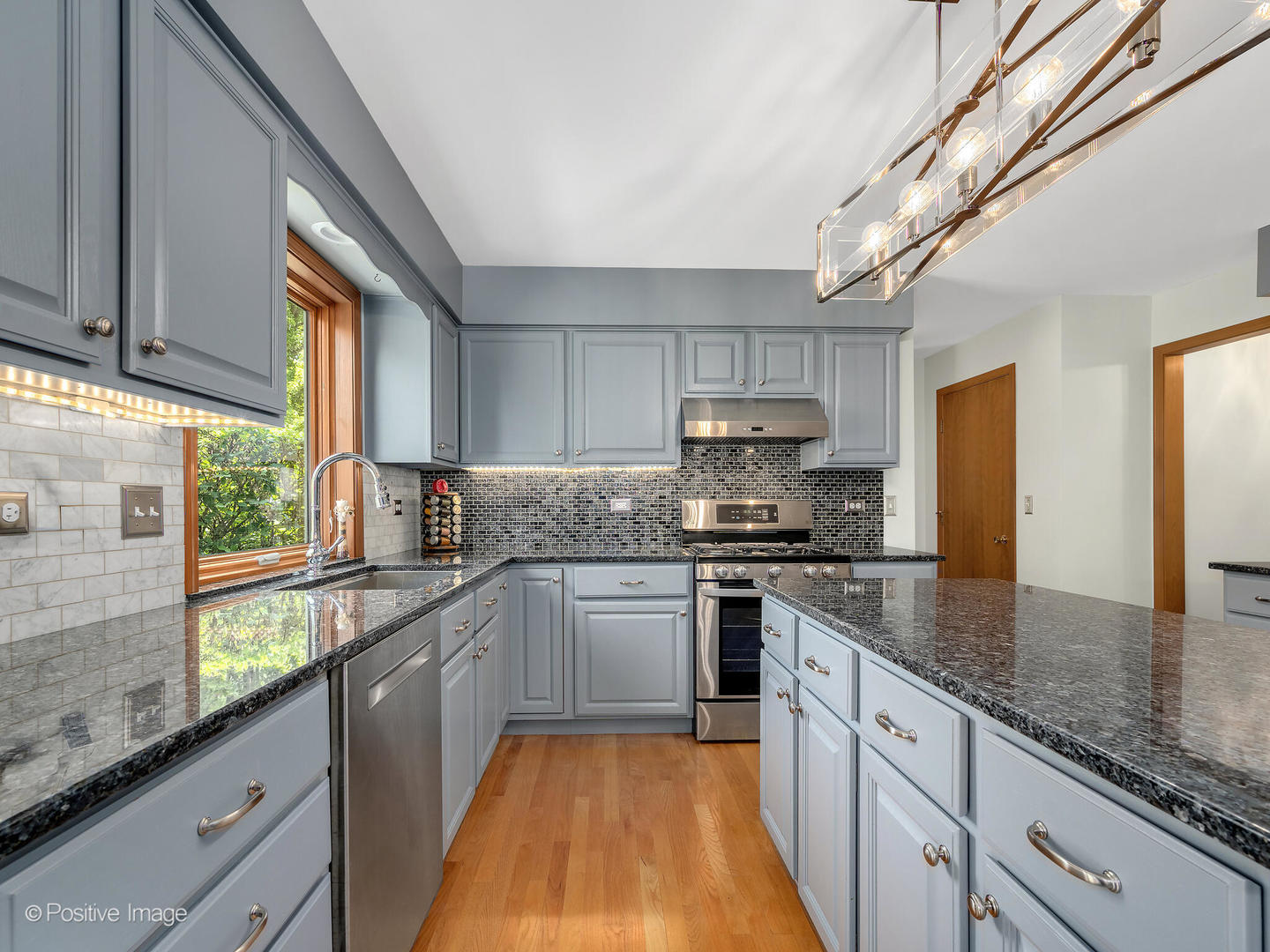 27W220 Jewell Road Winfield, IL 60190 - Photo 13 of 29 a kitchen with stainless steel appliances granite countertop a sink a stove and cabinets