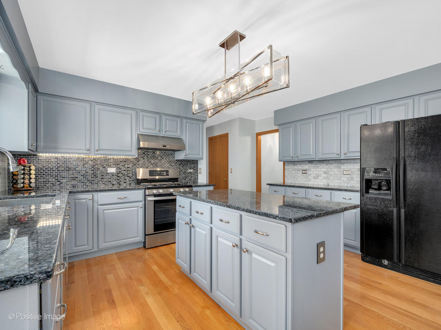 27W220 Jewell Road Winfield, IL 60190 - Photo 14 of 29 a kitchen with stainless steel appliances granite countertop a sink a stove a refrigerator cabinets and chairs