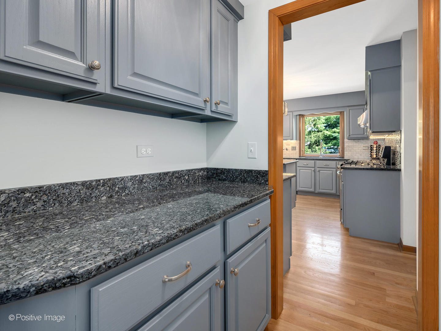 27W220 Jewell Road Winfield, IL 60190 - Photo 15 of 29 a kitchen with granite countertop cabinets stainless steel appliances and a wooden floor