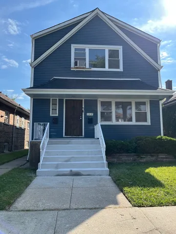 a front view of a house with a yard and plants
