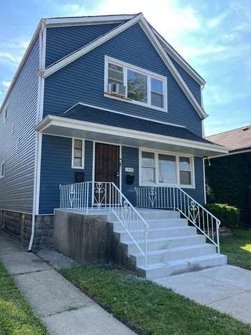 a view of a house with wooden fence next to a yard