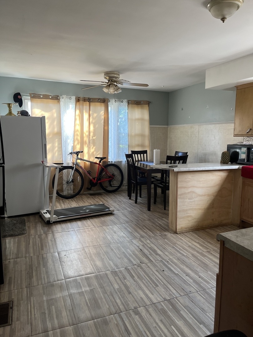11437 South Calumet Avenue Chicago, IL 60628 - Photo 4 of 11 a living room with furniture and a table