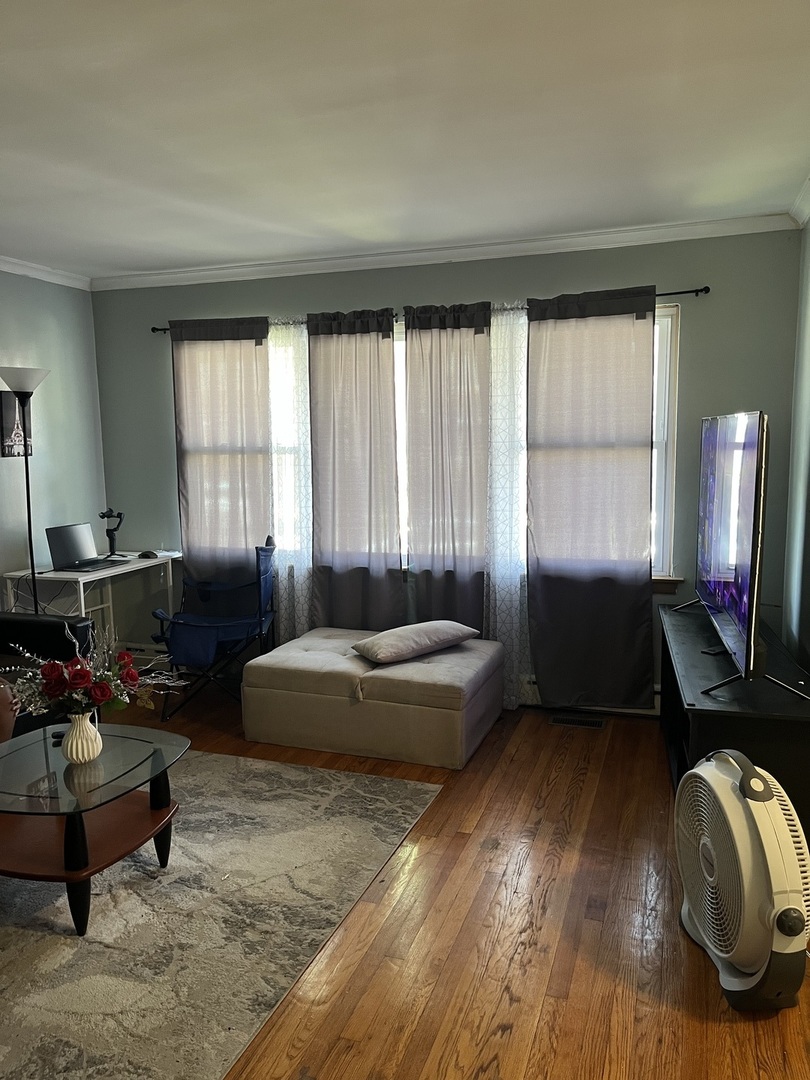 11437 South Calumet Avenue Chicago, IL 60628 - Photo 10 of 11 a living room with furniture and a window