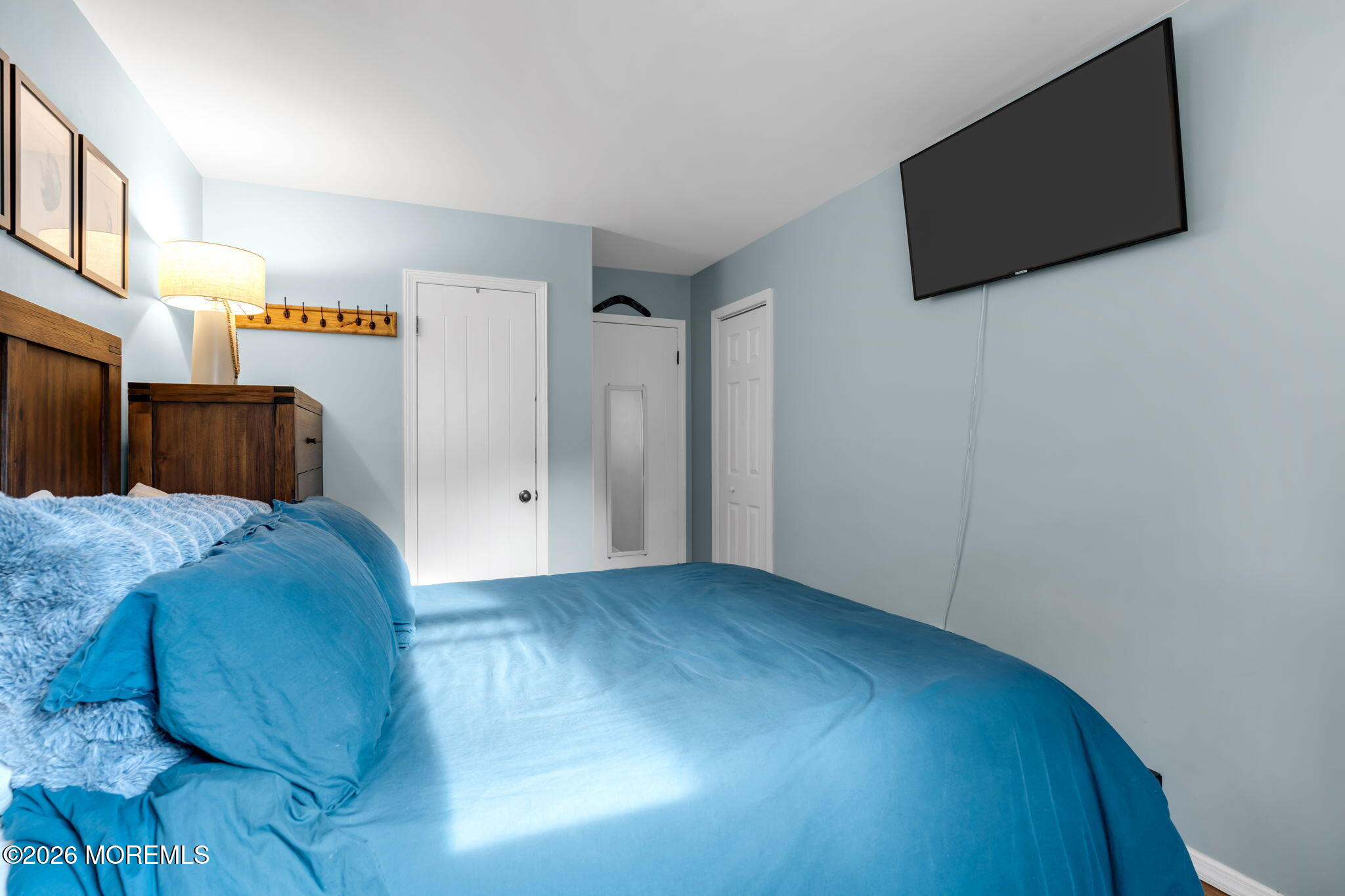 51 7th Street Belford, NJ 07718 - Photo 17 of 26 a view of a livingroom with wooden floor and a flat screen tv