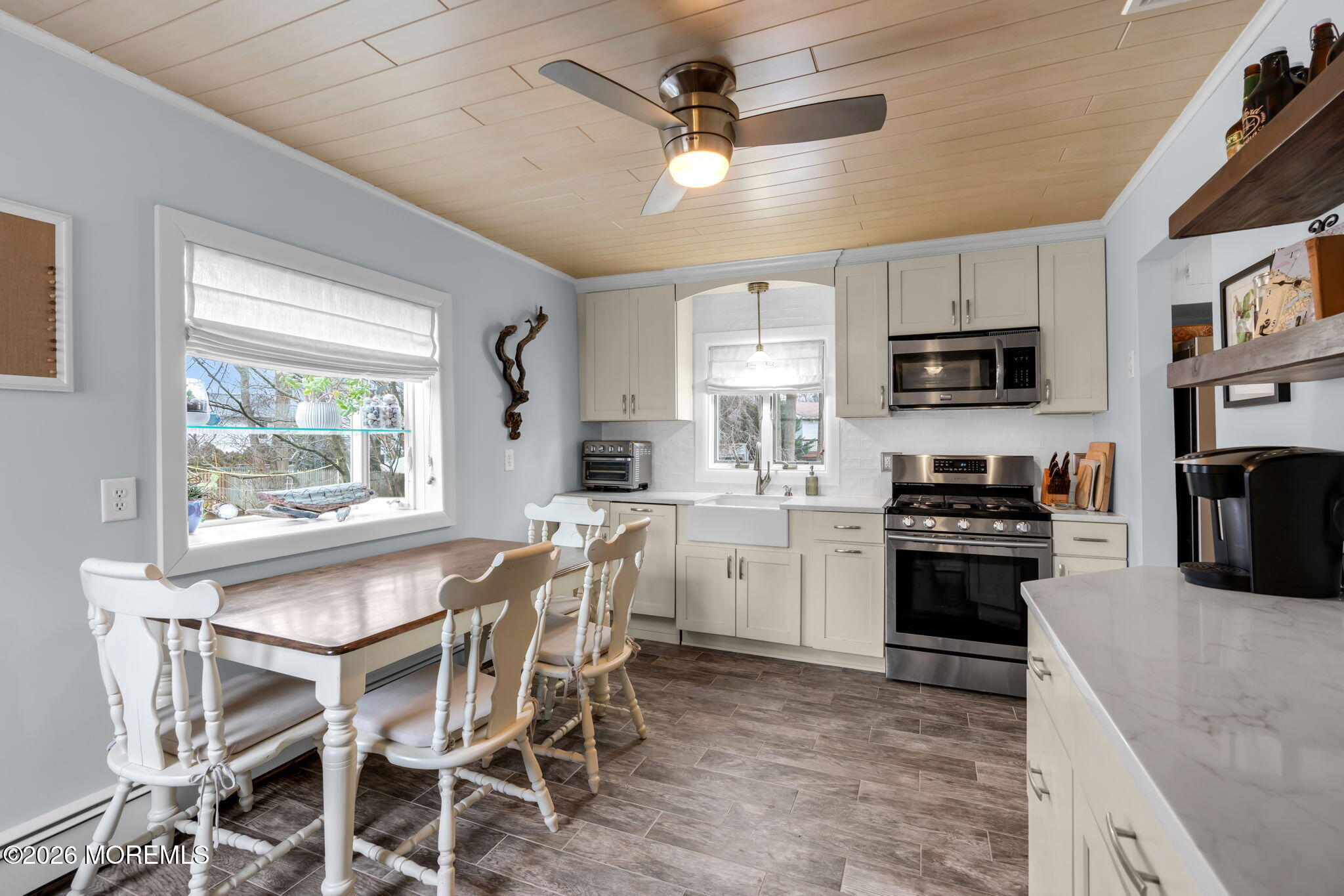 51 7th Street Belford, NJ 07718 - Photo 9 of 26 a kitchen with stainless steel appliances granite countertop a stove top oven a sink a stove a dining table and chairs