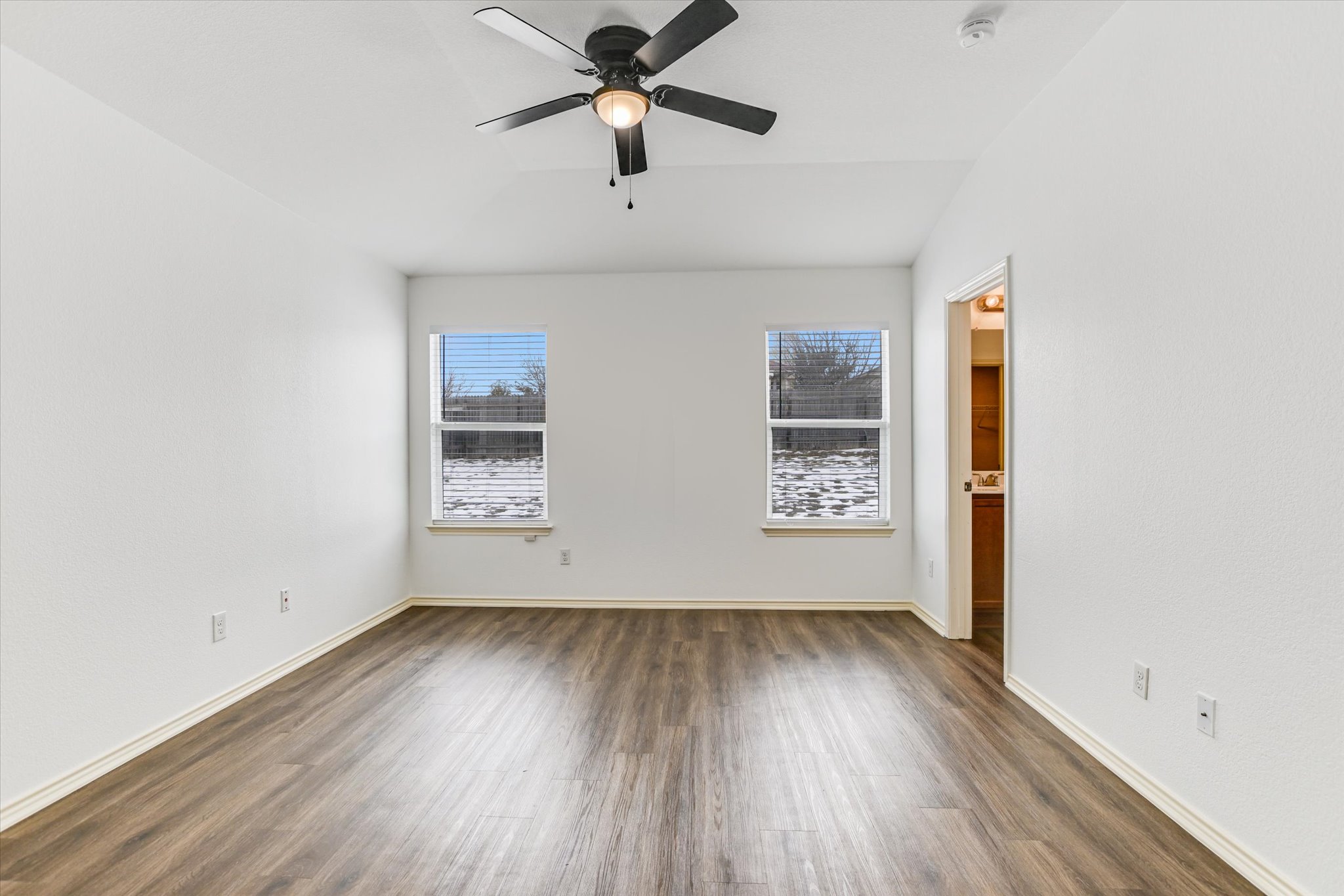 2864 Hearthsong Loop Round Rock, TX 78665 - Photo 13 of 29 Spare room with dark wood-type flooring, ceiling fan, and vaulted ceiling