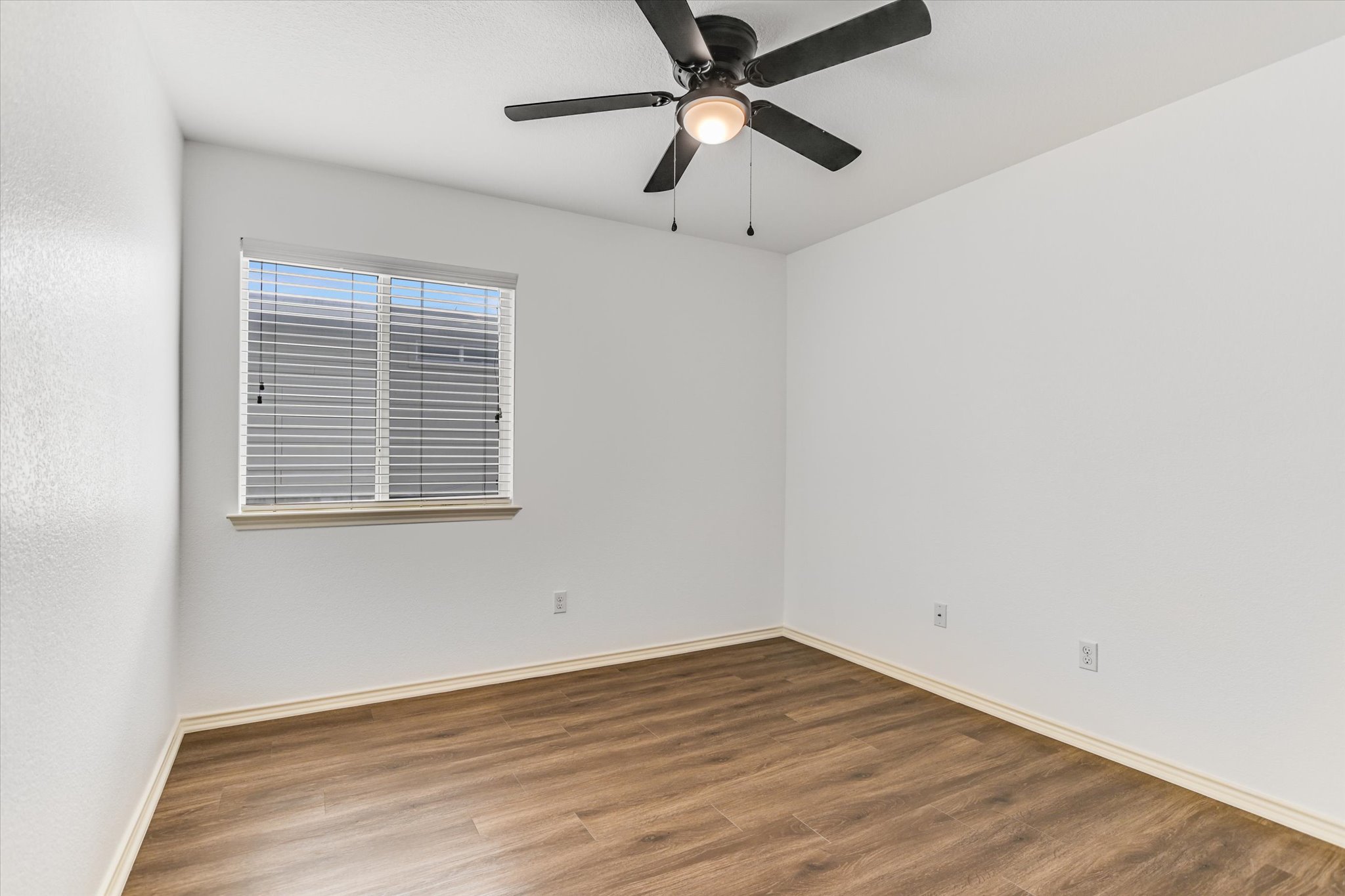 2864 Hearthsong Loop Round Rock, TX 78665 - Photo 15 of 29 Unfurnished room with wood finished floors and a ceiling fan