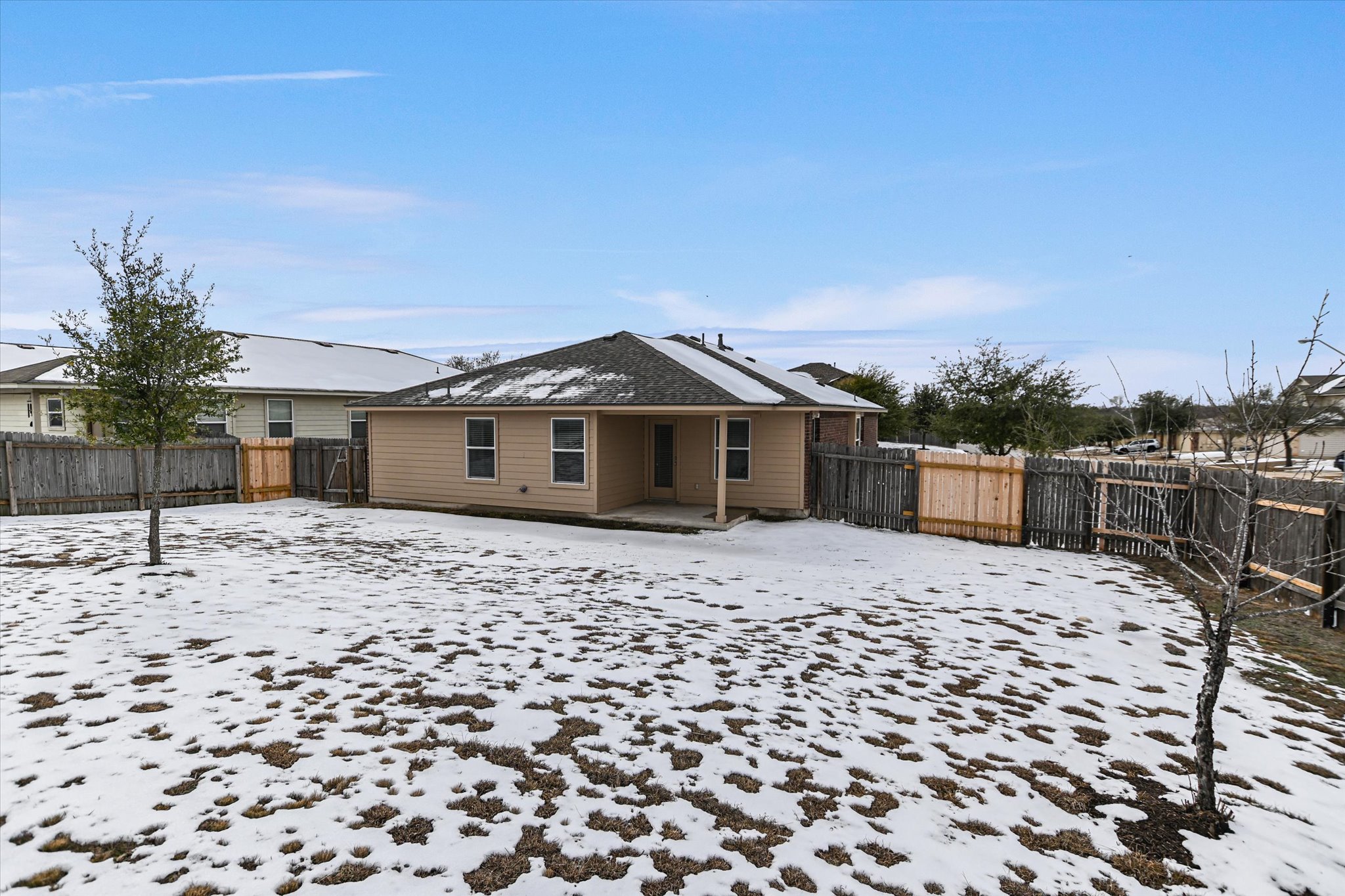 2864 Hearthsong Loop Round Rock, TX 78665 - Photo 19 of 29 Snow covered house featuring a patio area and a fenced backyard