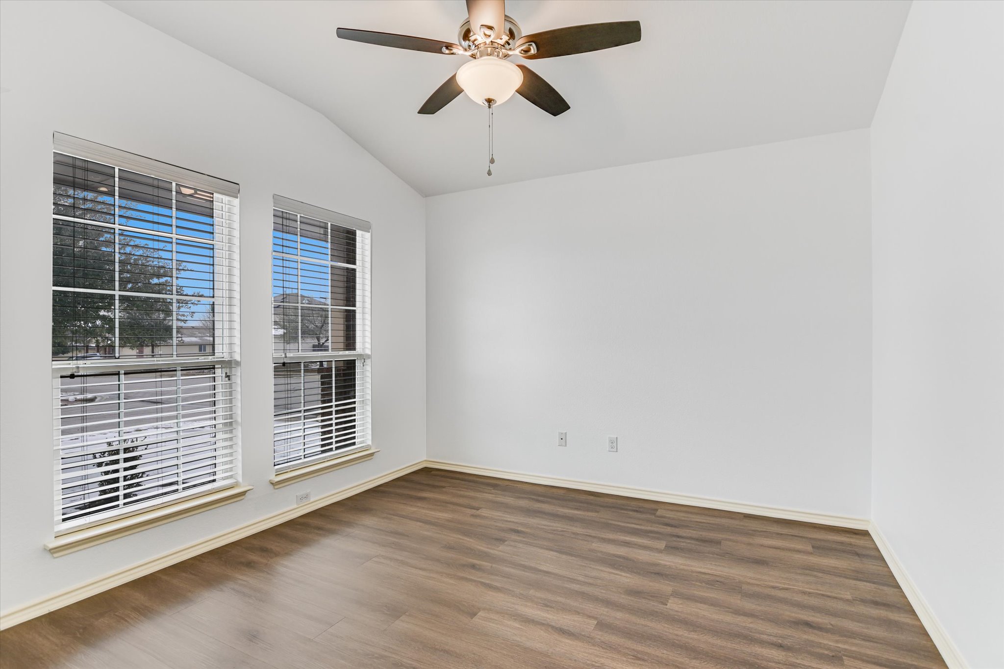 2864 Hearthsong Loop Round Rock, TX 78665 - Photo 4 of 29 Spare room with dark wood finished floors, lofted ceiling, and ceiling fan