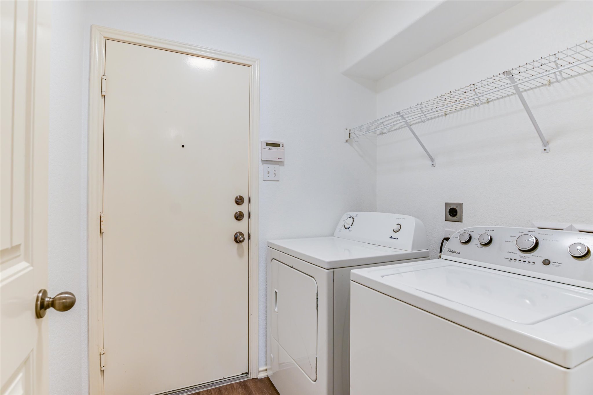 2864 Hearthsong Loop Round Rock, TX 78665 - Photo 10 of 29 Laundry area with dark wood-type flooring and washing machine and clothes dryer