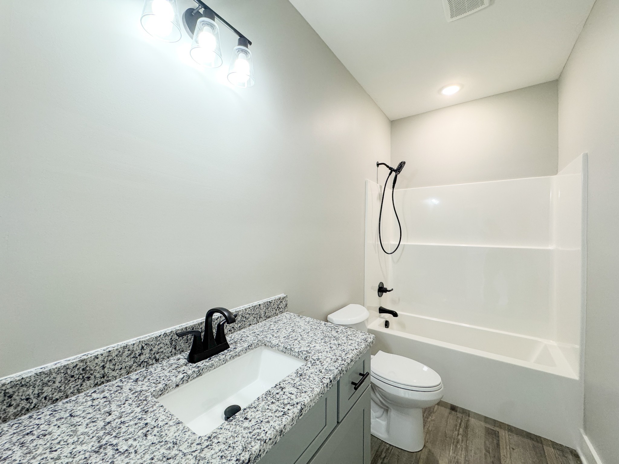 181 Rock House Hollow Road Bethpage, TN 37022 - Photo 32 of 51 a bathroom with a granite countertop sink a toilet and shower