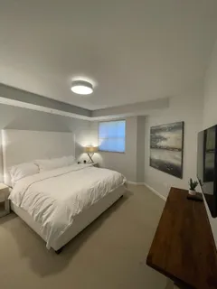 a bedroom with a bed and window