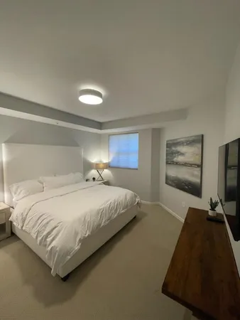a bedroom with a bed and window