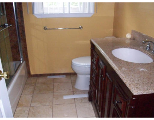 31 Lydia Road Coventry, RI 02816 - Photo 3 of 3 a bathroom with a granite countertop sink a toilet a mirror and vanity