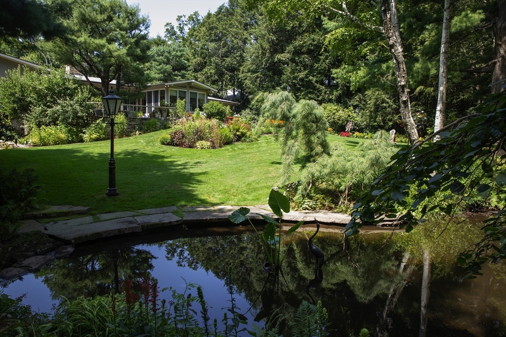 474 Salisbury Street Worcester, MA 01609 - Photo 1 of 40 a view of a garden with a lake