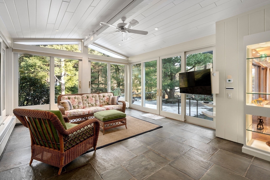 474 Salisbury Street Worcester, MA 01609 - Photo 15 of 40 a living room with furniture a flat screen tv and a floor to ceiling window