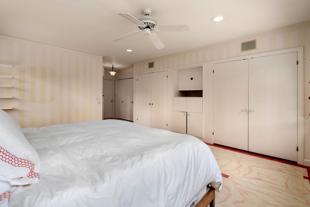 474 Salisbury Street Worcester, MA 01609 - Photo 24 of 40 a spacious bedroom with a bed and a ceiling fan