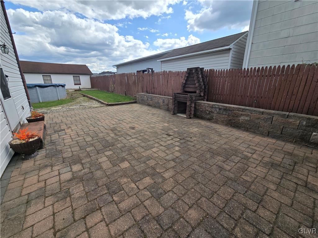 1015 Oak Street Coplay, PA 18037 - Photo 8 of 23 a view of backyard with barbeque grill and wooden fence