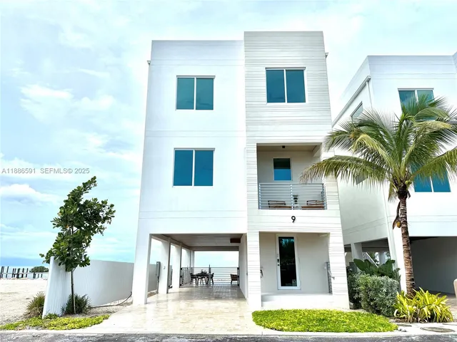 a front view of multiple houses with yard
