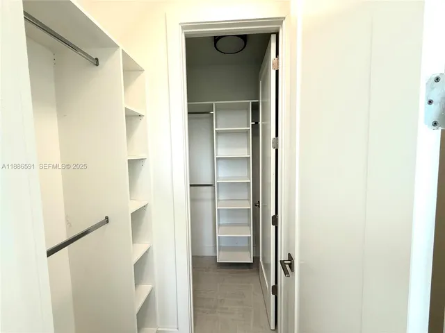 a bathroom with a sink vanity and shower