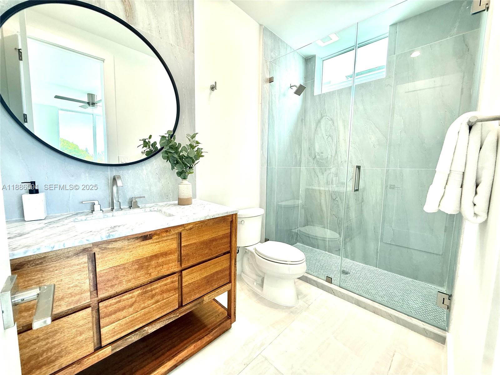 990 41st Gulf Street Marathon, FL 33050 - Photo 24 of 51 a bathroom with a double vanity sink toilet and shower