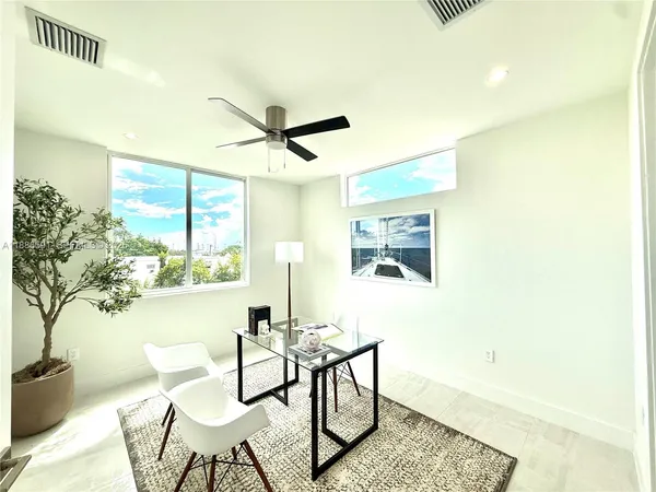 a dining room with furniture and a window