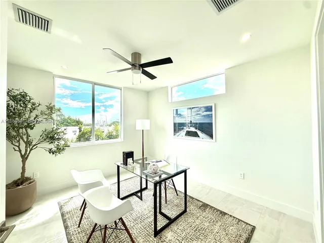 a dining room with furniture and a window